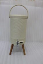Modern 5L cream beverage dispenser with wooden legs, digital temperature display, and chrome spigot sitting on a marble kitchen countertop.