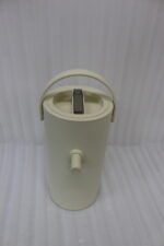 Minimalist off-white 2L insulated thermal water pitcher with carrying handle and dispenser spout on a marble kitchen countertop.