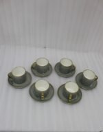 6-piece seafoam green ceramic tea cups with gold handles and matching saucers in a gift box
