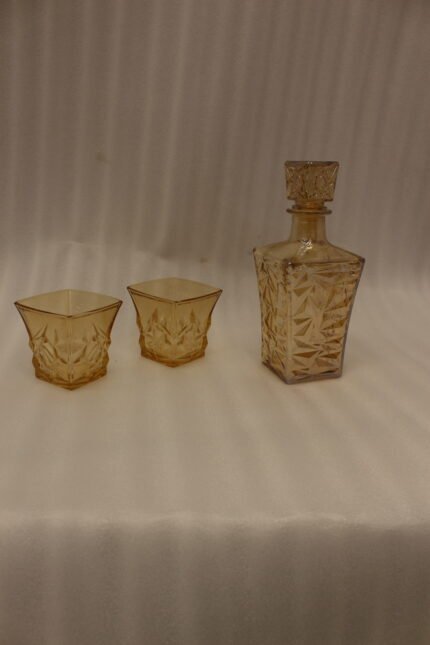 Amber-tinted 7-piece glass decanter and drinking glass set with diamond geometric texture on a marble countertop