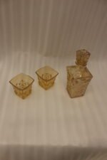 Amber-tinted 7-piece glass decanter and drinking glass set with diamond geometric texture on a marble countertop