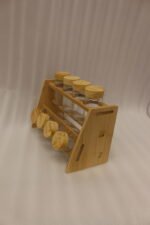 9-piece wooden spice rack with clear glass jars and matching wooden lids displayed on a white marble countertop