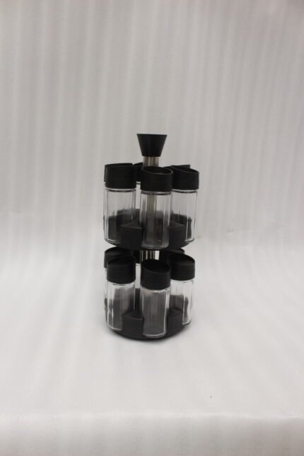 2-tier revolving spice rack set with clear glass jars and black caps on a granite countertop