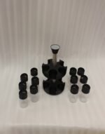 2-tier revolving spice rack set with clear glass jars and black caps on a granite countertop