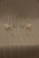 2 Pcs clear glass oil sprayer bottle set with ergonomic white trigger nozzles on a kitchen countertop