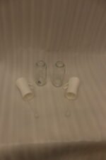 2 Pcs clear glass oil sprayer bottle set with ergonomic white trigger nozzles on a kitchen countertop