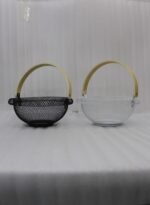 Black and white double wall mesh fruit baskets with wooden handles on a wooden countertop.
