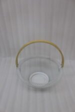Black and white double wall mesh fruit baskets with wooden handles on a wooden countertop.