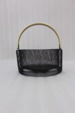 Black double-wall wire mesh fruit basket with a curved wooden handle sitting on a gray kitchen countertop.