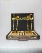 Luxury 52-piece gold stainless steel cutlery set featuring geometric textured handles lined up on a white marble surface.