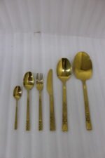 Luxury 52-piece gold stainless steel cutlery set featuring geometric textured handles lined up on a white marble surface.