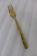Luxury 52-piece gold stainless steel cutlery set featuring geometric textured handles lined up on a white marble surface.