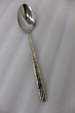 52 piece stainless steel cutlery set with silver and gold geometric pattern handles displayed on a white linen napkin