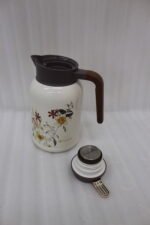 Three 2L vacuum thermal flasks with vintage floral patterns and ergonomic handles on a kitchen counter