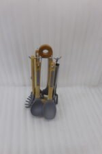 7 piece silicone cooking utensil set with wooden handles on a rotating stand