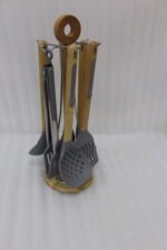 7 piece silicone cooking utensil set with wooden handles on a rotating stand
