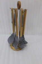 7 piece silicone cooking utensil set with wooden handles on a rotating stand