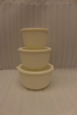 Stacked 3-piece white fluted food storage containers with clear airtight lids on a kitchen counter