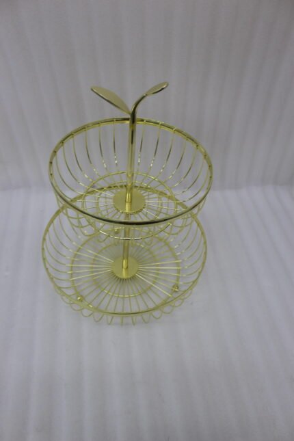 Modern 2-tier gold metal wire fruit basket holder on a wooden dining table