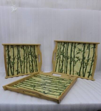 Set of wooden serving trays with printed bamboo stalk patterns resting on a kitchen countertop.