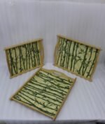 Set of wooden serving trays with printed bamboo stalk patterns resting on a kitchen countertop.