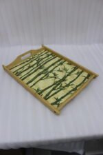 Set of wooden serving trays with printed bamboo stalk patterns resting on a kitchen countertop.