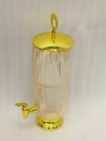 3.5L ribbed pink glass beverage dispenser with ornate gold base, spout, and top handle standing on a kitchen marble countertop