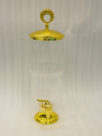 Luxury 3.5 liter ribbed glass beverage dispenser with ornate gold lid handle and gold spigot on a marble countertop