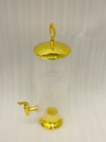 Luxury 3.5 liter ribbed glass beverage dispenser with ornate gold lid handle and gold spigot on a marble countertop