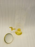 Luxury 3.5 liter ribbed glass beverage dispenser with ornate gold lid handle and gold spigot on a marble countertop