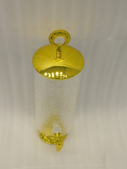 Luxury 3.5L amber ribbed glass beverage dispenser with ornate gold base, spigot, and lid handle on a kitchen countertop.