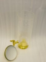 Luxury 3.5L amber ribbed glass beverage dispenser with ornate gold base, spigot, and lid handle on a kitchen countertop.