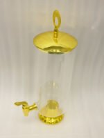 3.5 liter ribbed glass beverage dispenser with polished gold base, lid, and spigot on a kitchen counter