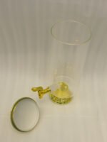 3.5 liter ribbed glass beverage dispenser with polished gold base, lid, and spigot on a kitchen counter
