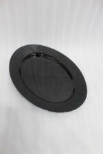 38-piece glossy black opal glass dinner set displayed on a wooden dining table, featuring plates, bowls, cups, and serving dishes.