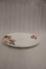 38 piece opal glass dinner set with vintage floral rose patterns on a wooden dining table