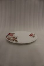 38 piece opal glass dinner set with vintage floral rose patterns on a wooden dining table