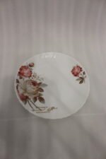 38 piece opal glass dinner set with vintage floral rose patterns on a wooden dining table