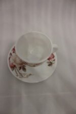 38 piece opal glass dinner set with vintage floral rose patterns on a wooden dining table