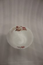 38 piece opal glass dinner set with vintage floral rose patterns on a wooden dining table