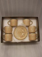 Elegantly boxed beige ceramic 6-person cup and saucer set featuring textured patterns and gold trim handles.