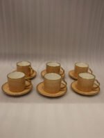 Elegantly boxed beige ceramic 6-person cup and saucer set featuring textured patterns and gold trim handles.
