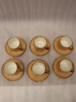 Elegantly boxed beige ceramic 6-person cup and saucer set featuring textured patterns and gold trim handles.