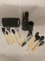 Matte dark grey 19-piece kitchen utensil and knife block set with rose gold accents and wooden handles on a marble countertop.