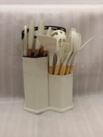 19-piece cream silicone kitchen utensil and knife set with wooden handles arranged in a matching ribbed counter holder