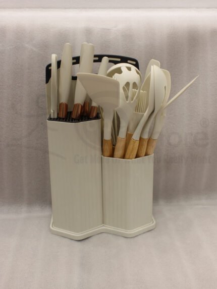 19-piece cream silicone kitchen utensil and knife set with wooden handles arranged in a matching ribbed counter holder