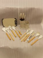 19-piece cream silicone kitchen utensil and knife set with wooden handles arranged in a matching ribbed counter holder
