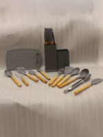 Modern grey 19-piece silicone kitchen utensil and knife set with wooden handles in a matching storage caddy on a countertop
