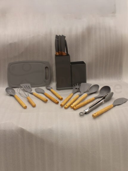 Modern grey 19-piece silicone kitchen utensil and knife set with wooden handles in a matching storage caddy on a countertop