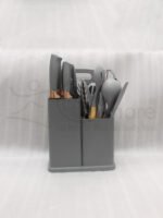 Modern grey 19-piece silicone kitchen utensil and knife set with wooden handles in a matching storage caddy on a countertop